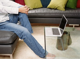 picture of laptop on glass coffee table in living room