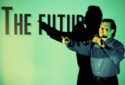 picture of male professor pointing in front of projection screen that says "the future"