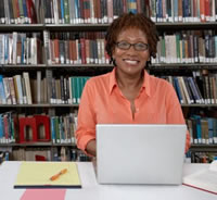 image of woman in librry with laptop