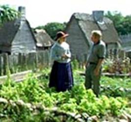 A visitor discusses 17th century gardening with a villager